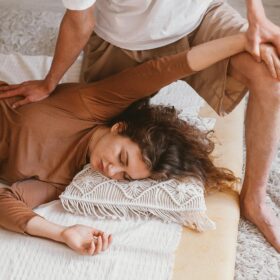 Relaxing indoor massage session capturing warmth and comfort with a focus on therapeutic techniques.