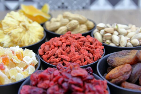 A vibrant collection of dried fruits and nuts in bowls, ideal for nutrition and healthy eating concepts.