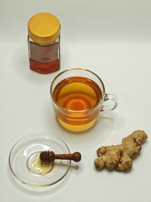 A harmonious composition of ginger tea, honey, and ginger root. Perfect for health themes.