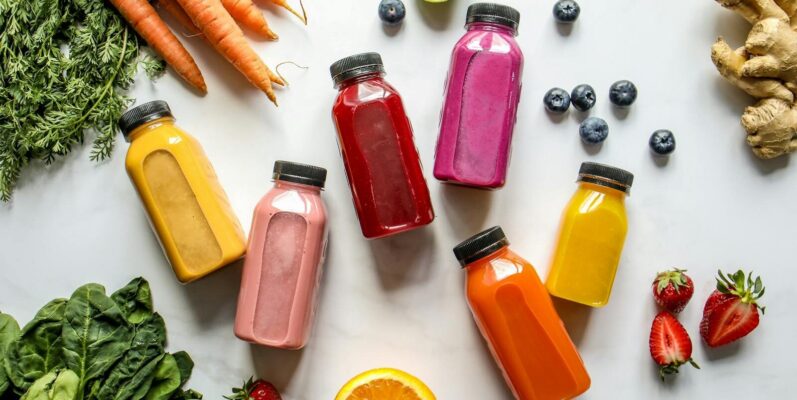 Colorful assortment of organic juices with fresh ingredients for a healthy lifestyle.