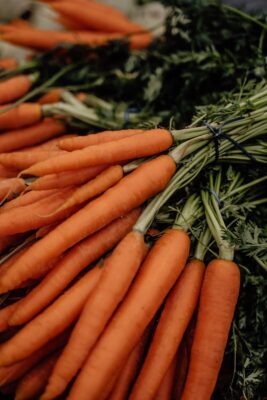 Freshly harvested organic carrots bundled together at a vibrant market in Erfurt, Germany.