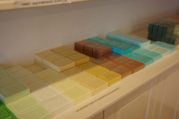Rows of colorful tiles arranged by shade on a shelf.