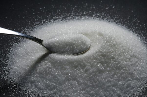 a spoon full of sugar on top of a table
